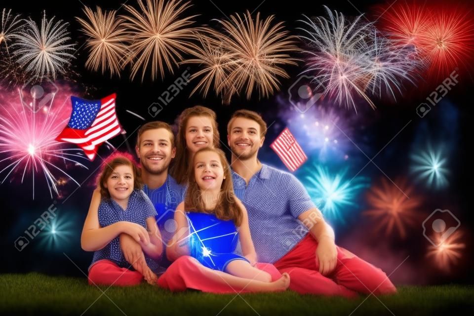 American family celebrating Independence Day. Picnic and fireworks on 4th of July in America. USA flag. Parents and kids celebrate US holiday. children watching fireworks.
