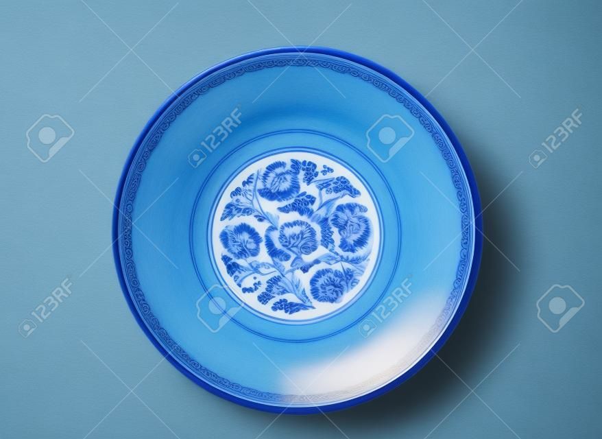 Directly above an empty blue china bowl