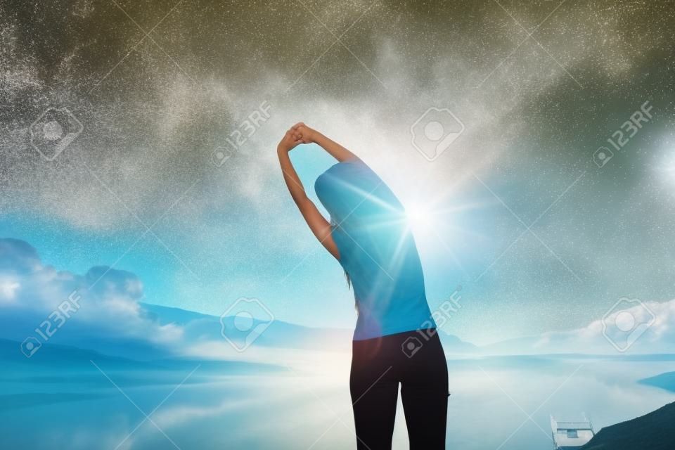woman enjoy the morning and raise arm