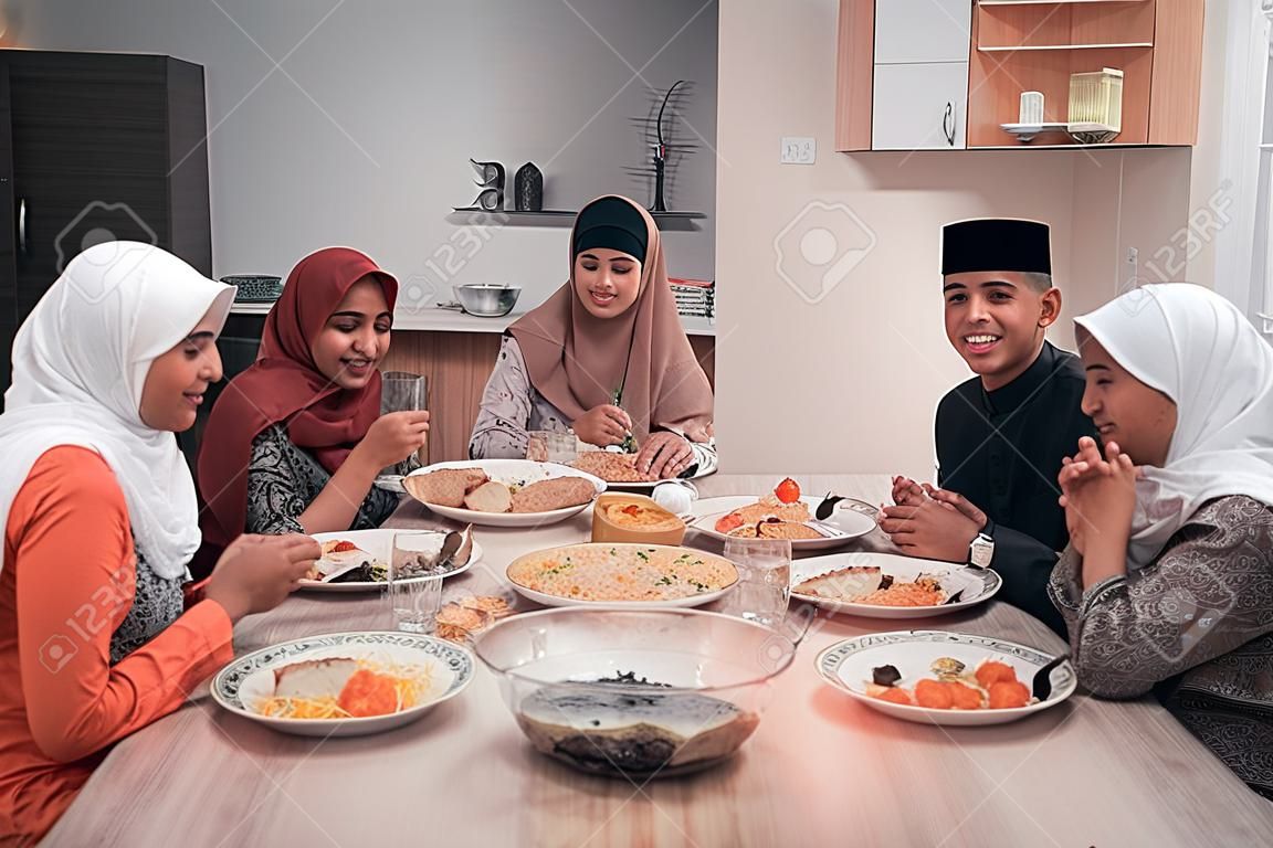 happy muslim having dinner at home break fasting on ramadan