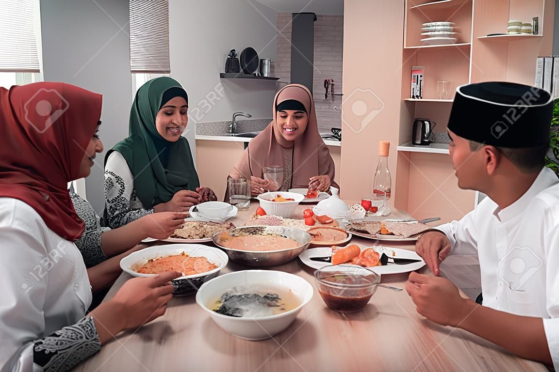 happy muslim having dinner at home break fasting on ramadan