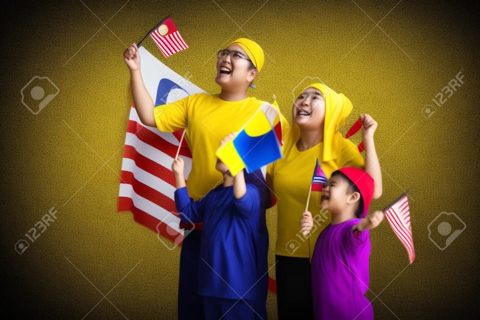 malaysia family with attributes and flag celebrating