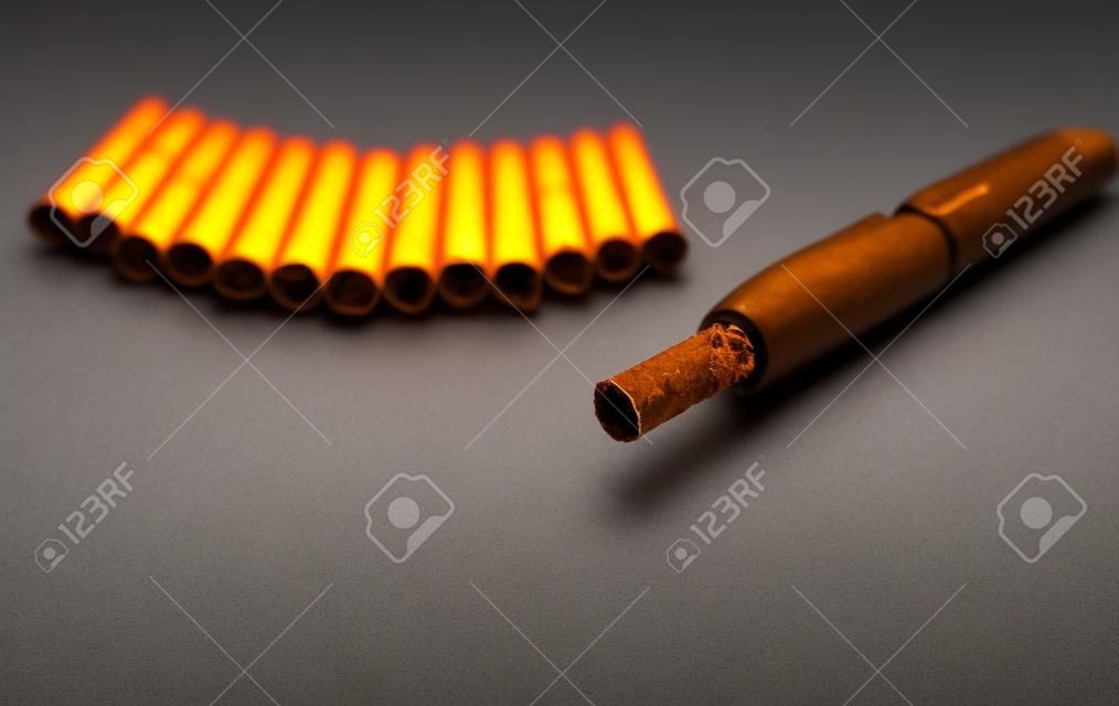 Tobacco heating system and a pack of tobacco sticks on a gray background