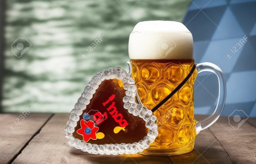 big glass filled with Bavarian lager beer and souvenir heart from Oktoberfest