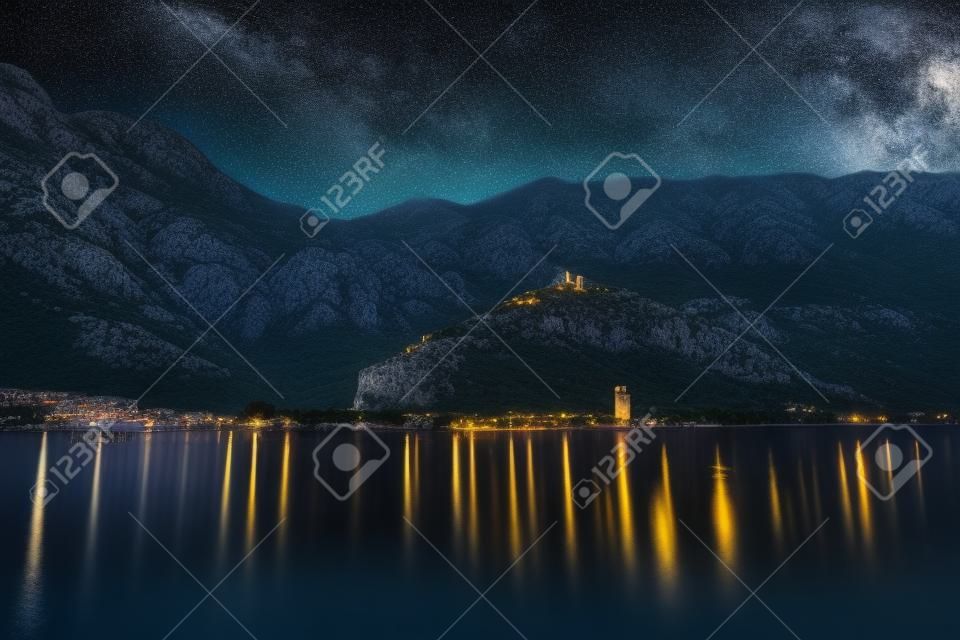 山と古代コトルの町と地中海の夜の風景。空の要塞と星