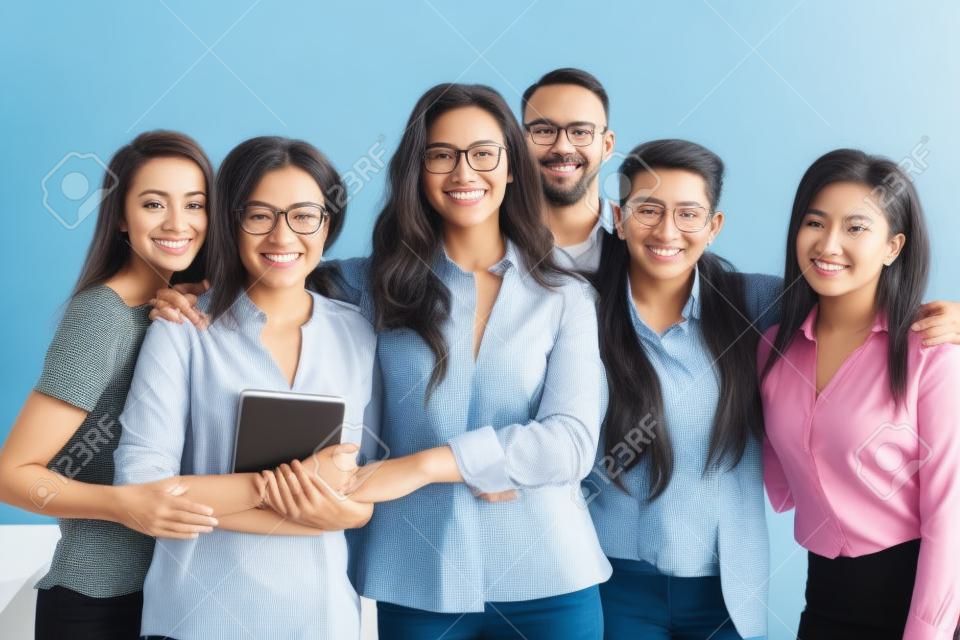 All for one. Group portrait of happy ambitious motivated multiethnic business partners specialists team workforce of diverse gender and age standing close together hugging smiling looking at camera