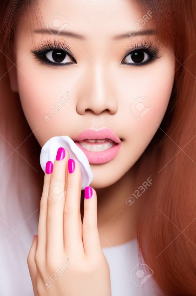 Asian woman removing make-up