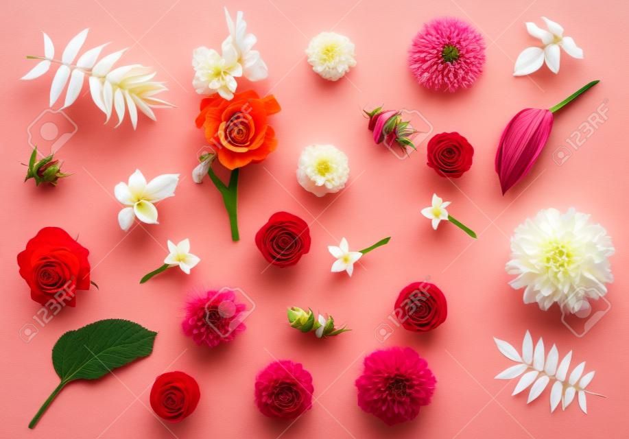 Flowers of roses, dahlias, gladiolus, tobacco, marigolds and leaves host, astilbe and Ricinus communis isolated on white background. Flora composition and collection. Nature and plants. Red, pink. Flat lay, top view 