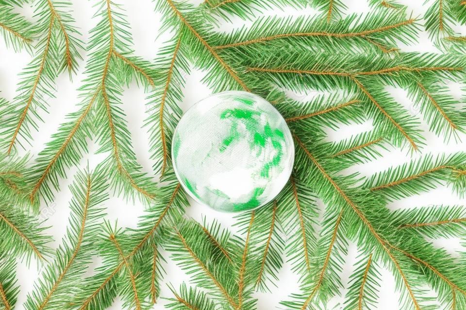 Rubber globe spruce branches, christmas tree texture or background on a white table. New Year. Flat lay, top view. 