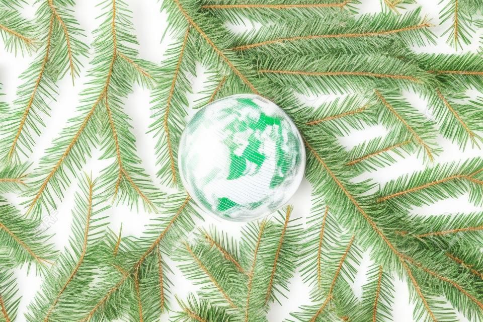 Rubber globe spruce branches, christmas tree texture or background on a white table. New Year. Flat lay, top view. 