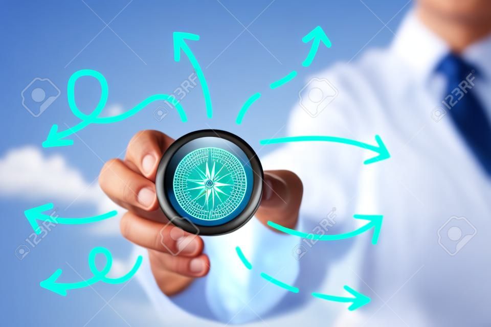 Businessman and compass showing direction concept for guidance, strategy and business orientation