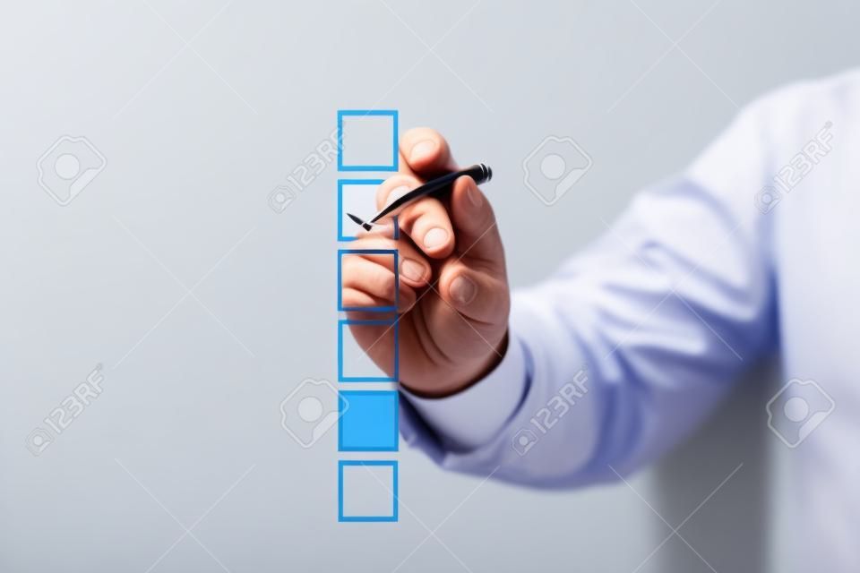 Blank checklist on whiteboard with businessman hand drawing a red check mark in one checkbox