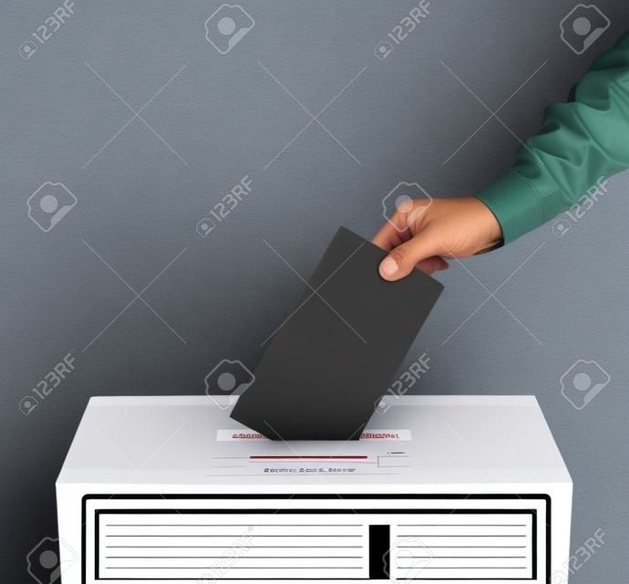 Urna con la persona que emite el voto en la boleta de votación en blanco