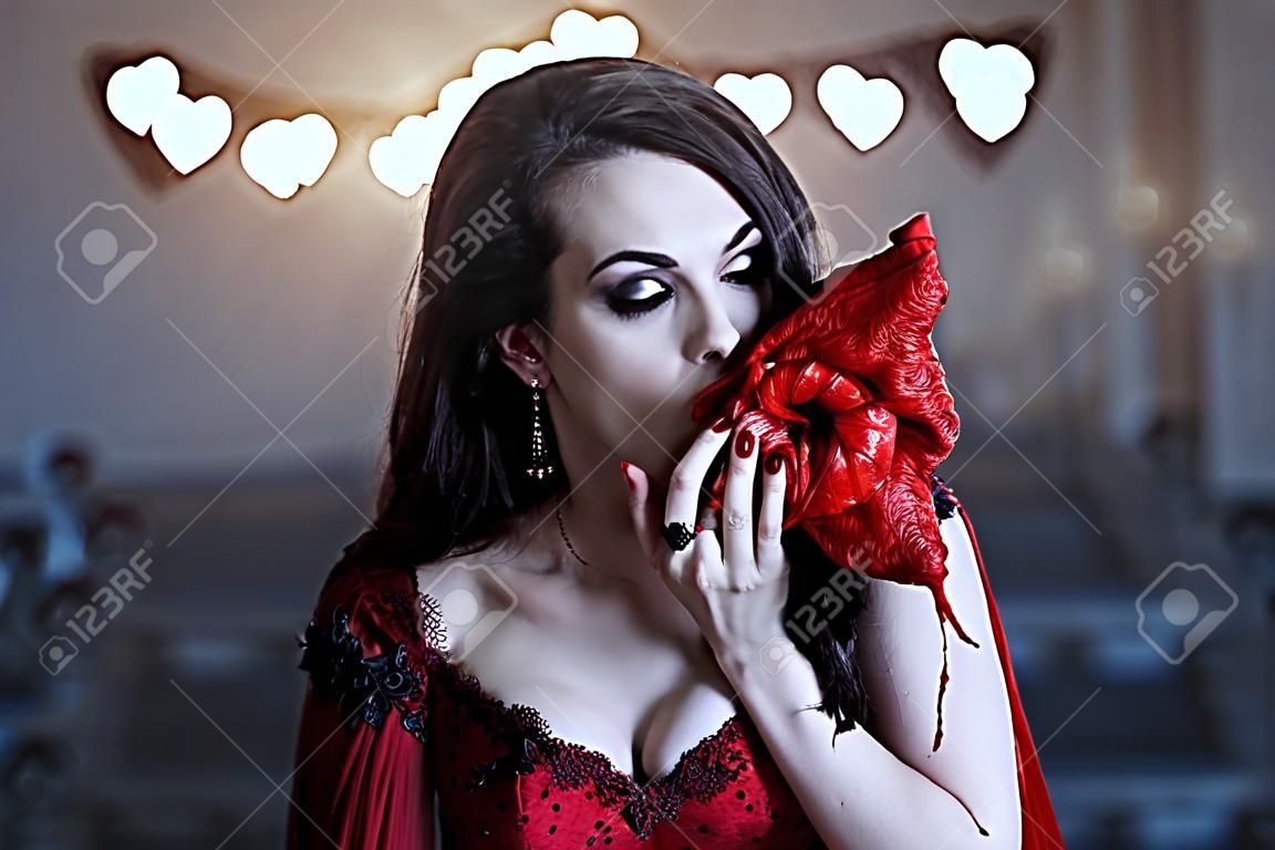 Żądna krwi wampirzyca w czerwonej sukience. średniowieczne wnętrze