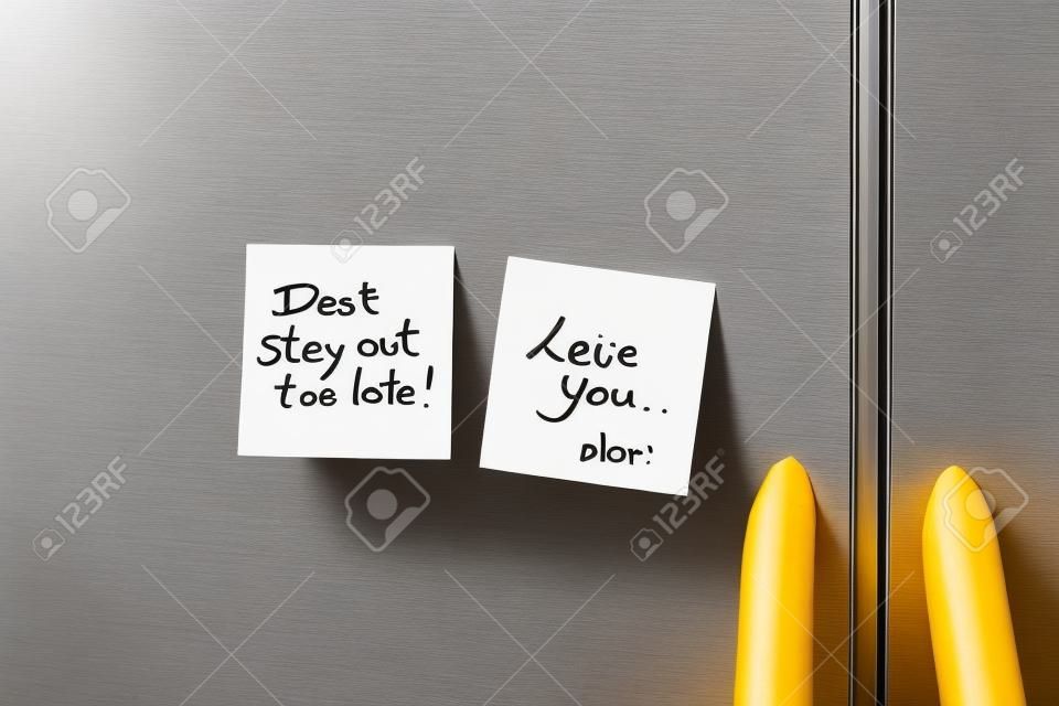 Friendly sticky notes on a kitchen refrigerator door in a home 