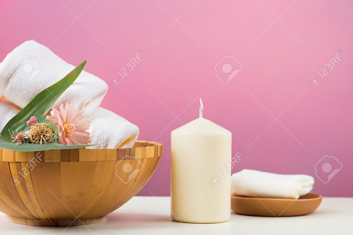 Spa still life with aromatic candles, flower and towel. - Image