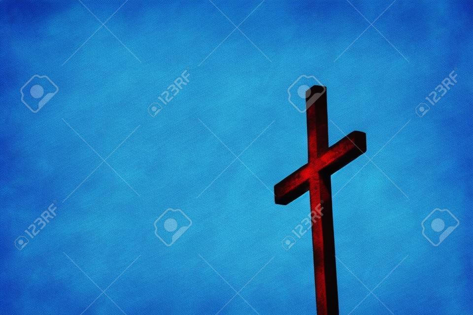 Rusty ijzeren kruis tegen een blauwe achtergrond - Afbeelding met kopieerruimte