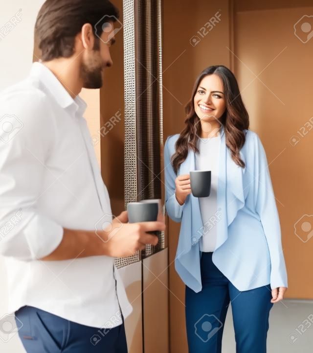 A man and a woman talking in a coffee break