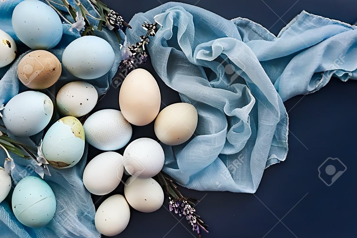 Easter background with blue colored eggs and napkin. Top view