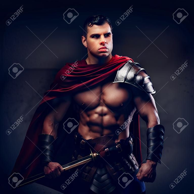 Brutal ancient Greece warrior with a muscular body in battle uniforms