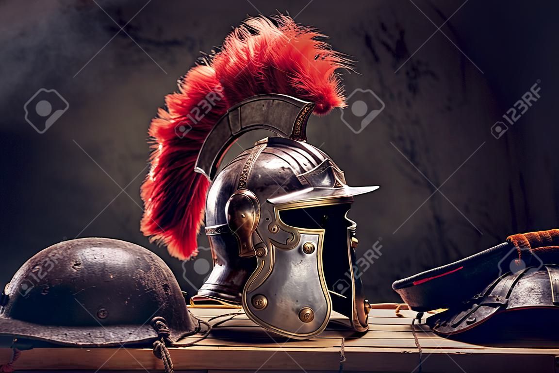Complete combat equipment of the ancient Greek warrior lie on a box of wooden boards.