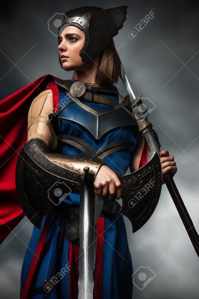 Medieval warrior lady with axe and spear looking away