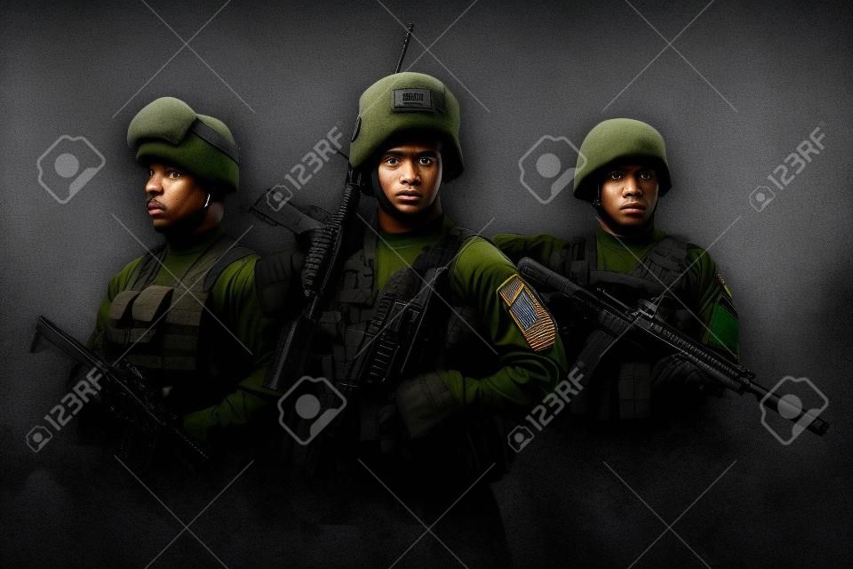 Shot of squad of three soldiers against gray background