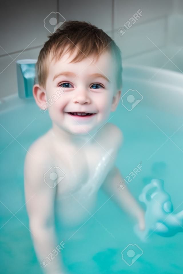 a little boy bathes in bath