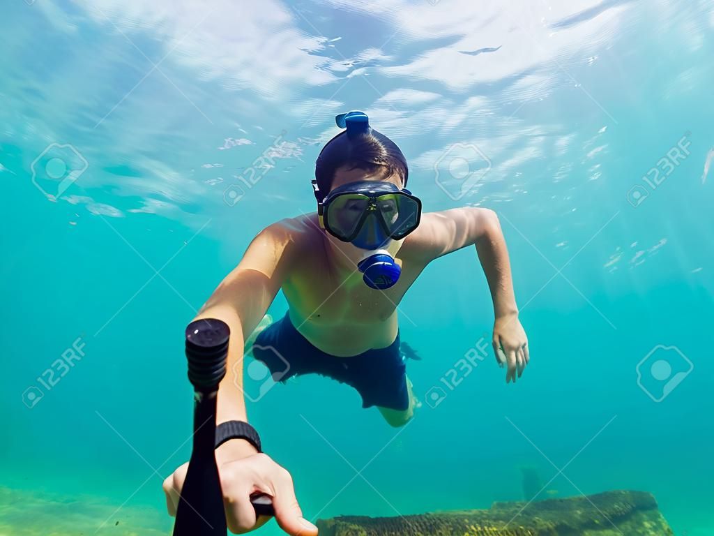 A young caucasian snorkeling man under water selfie Thailand