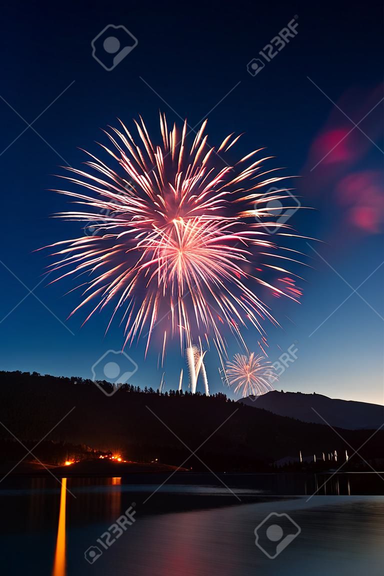 Fireworks Exploding Over a Mountain Lake.