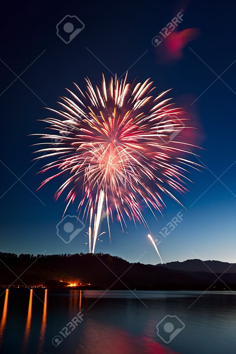 Fireworks Exploding Over a Mountain Lake.
