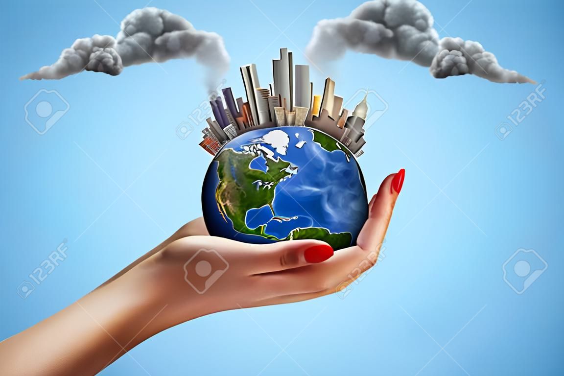 Side closeup of woman's hand facing up and holding small Earth with skyscraper city on it emitting plumes of grey smoke in air on light-blue background. Save nature. Stop pollution. Go green.