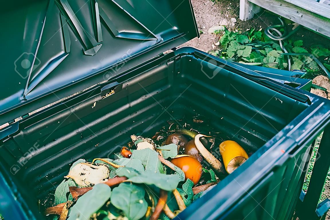 Close up view of organic waste inside compost bin. Organic farming and healthy lifestyle concept