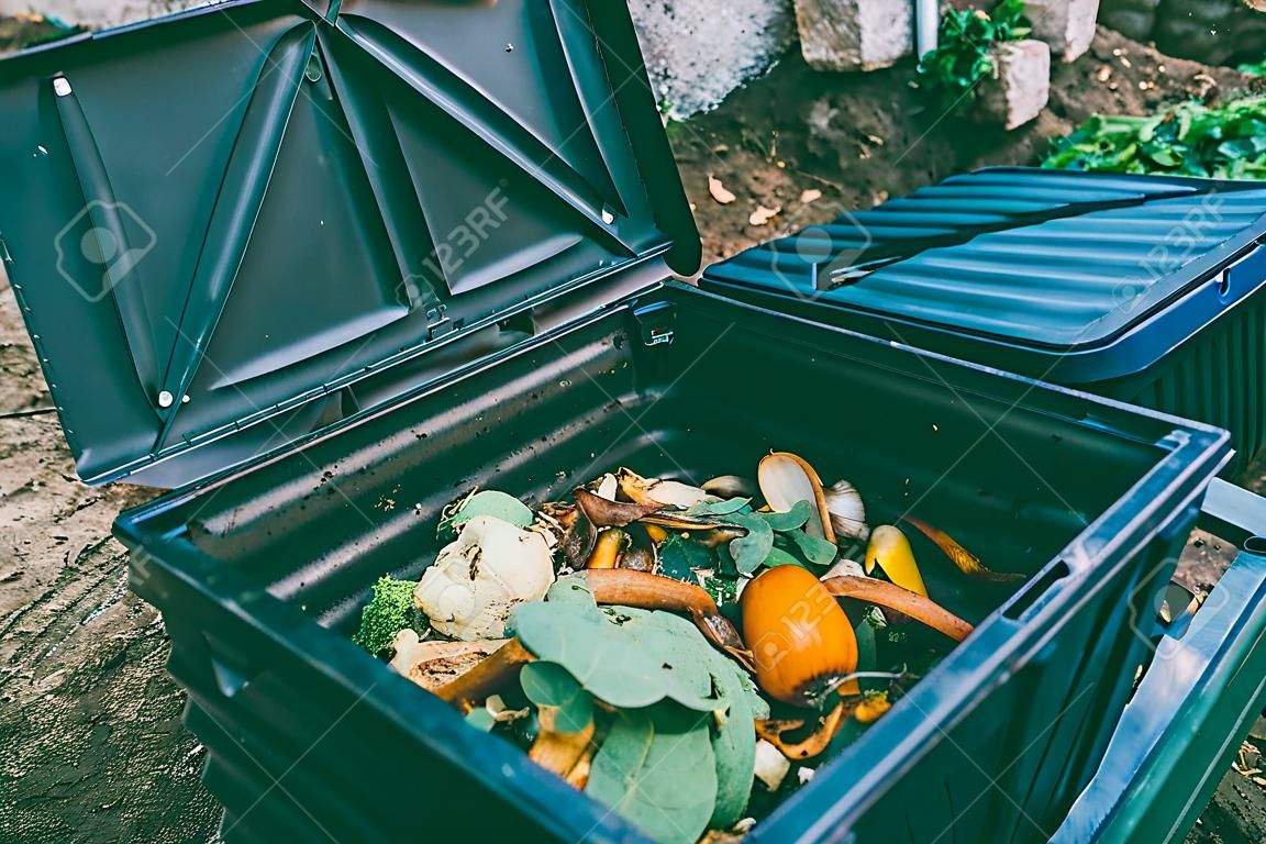 Close up view of organic waste inside compost bin. Organic farming and healthy lifestyle concept