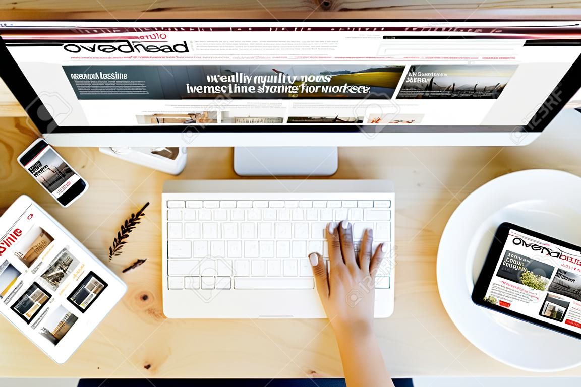 overhead desktop with e-magazine on devices screen