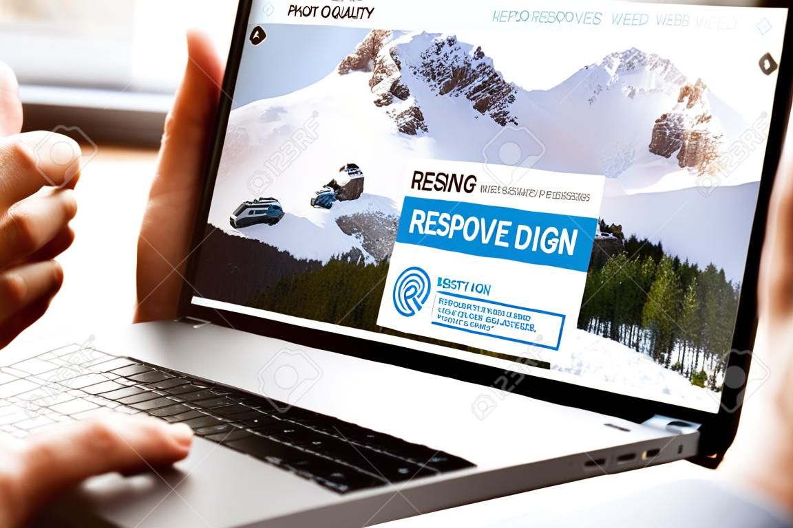 User opening laptop showing responsive web design website