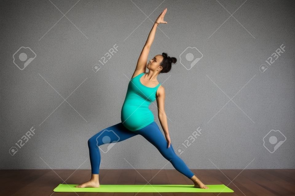 Beautiful pregnant woman workout. Doing fitness on last months of pregnancy. Yoga positions.