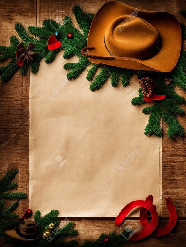 Occidental del fondo de Navidad con sombrero de vaquero y papel viejo para el texto