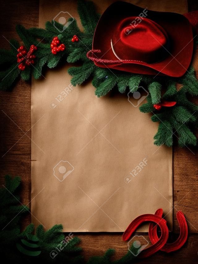 Occidental del fondo de Navidad con sombrero de vaquero y papel viejo para el texto