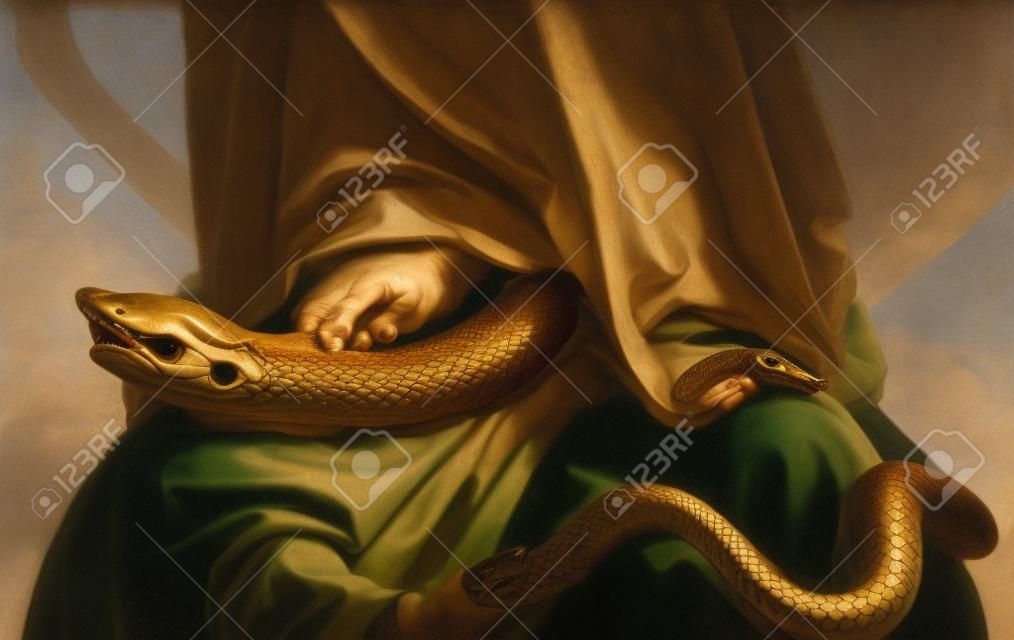 The Virgin Mary crushing the serpent of original sin with his foot. Defocused blurry background.