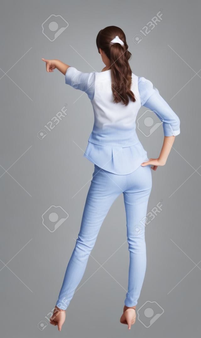  woman pointing. Back view . beautiful brunette girl in shirt gesture.  Rear view people collection.  backside view of person.  Isolated over white background.