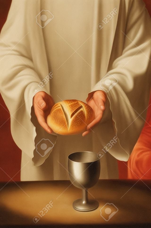 Manos de Jesús sosteniendo el pan en la mesa de comunión