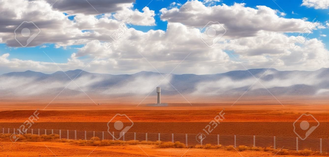 Concentrated solar power plant, CSP. Tower and mirrors, solar thermal energy, Blue sky with clouds, spring day in desert, United States