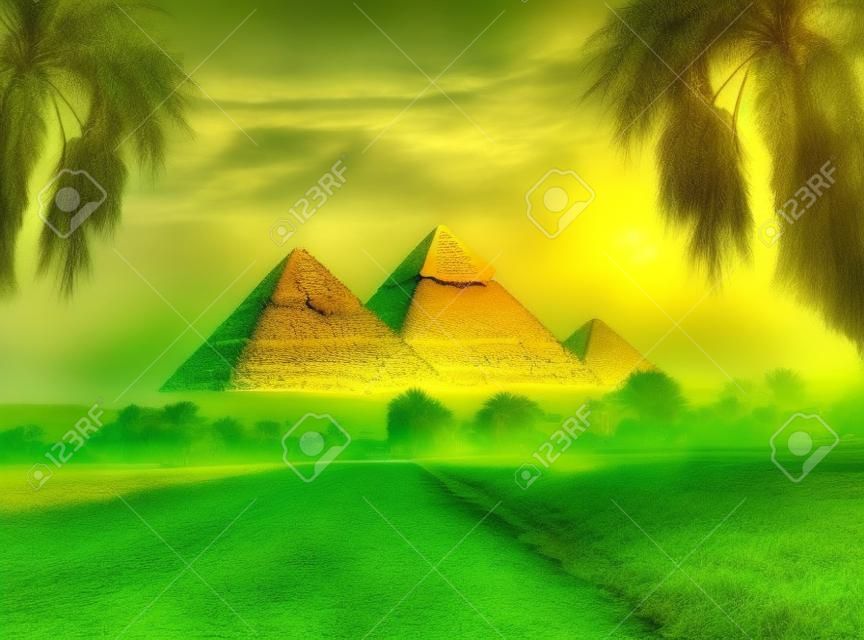 Pyramides égyptiennes dans un champ vert au matin brumeux