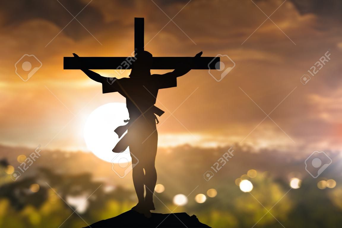Silhouette of Jesus with Cross over sunset concept for religion worship Christmas Easter Redeemer Amazing grace prayer and praise Thanksgiving dramatic sky vintage redeemer life
