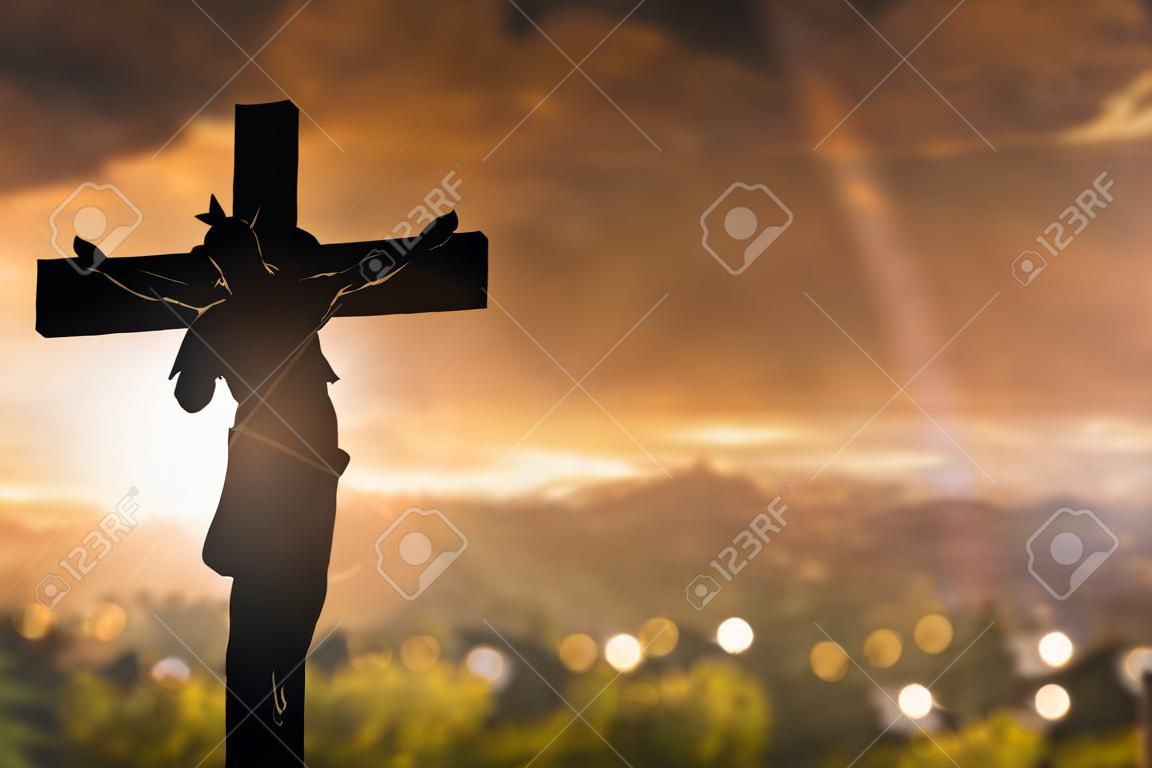 Silhouette of Jesus with Cross over sunset concept for religion worship Christmas Easter Redeemer Amazing grace prayer and praise Thanksgiving dramatic sky vintage redeemer life