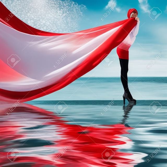 Woman with red scarf on water