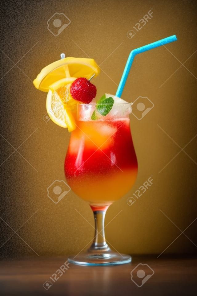Mai Tai mixed drink with fruit and umbrella garnish on whte background