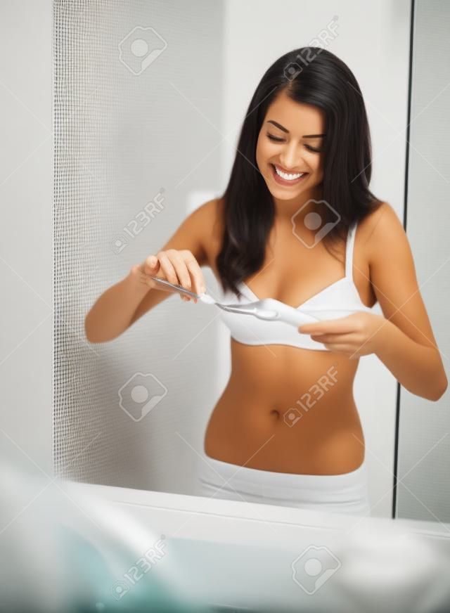 Morning routine by brushing teeth in bathroom 