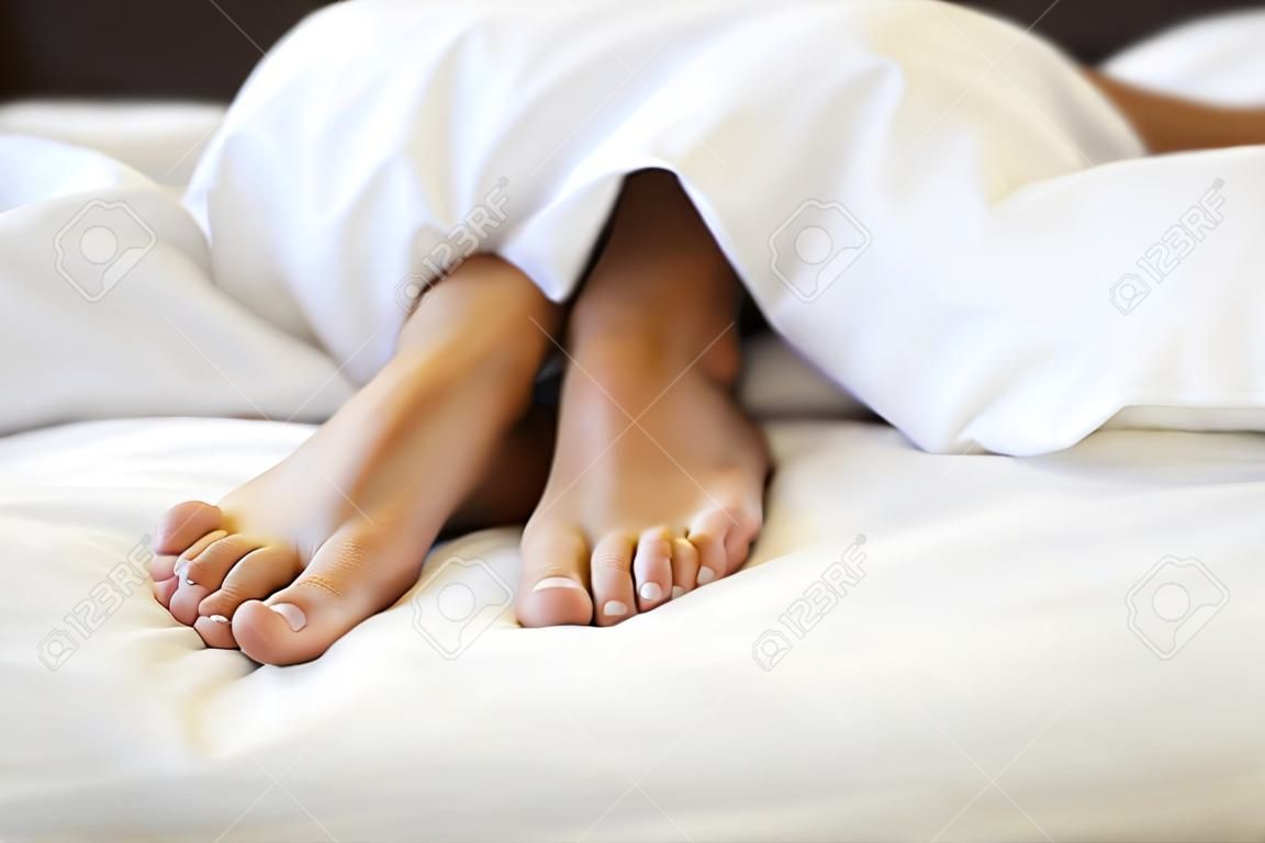 Close up of female feet in bed